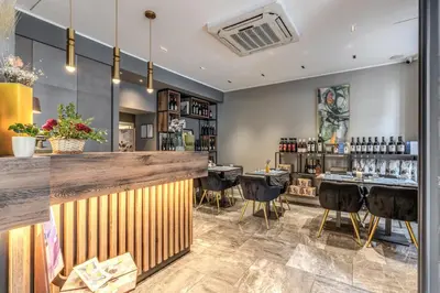 a bar in a restaurant with bar stools at Apollo Boutique Hotel in Rome