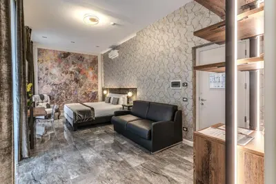 a hotel room with a bed and a couch at Apollo Boutique Hotel in Rome