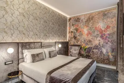a bedroom with a bed and a wall mural at Apollo Boutique Hotel in Rome