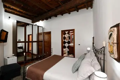 a bedroom with a bed and a mirror at Vicolo dell'Aquila - Residenze Romanae in Rome