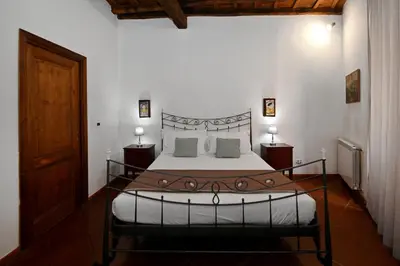 a bedroom with a large bed and two night stands at Vicolo dell'Aquila - Residenze Romanae in Rome
