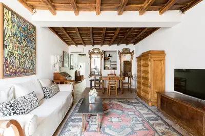 a living room with a couch and a tv at Classic and chic apartments in Trastevere in Rome