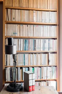 a book shelf filled with lots of books at Classic and chic apartments in Trastevere in Rome