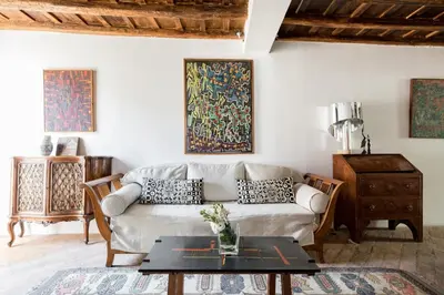 a living room with a couch and a table at Classic and chic apartments in Trastevere in Rome
