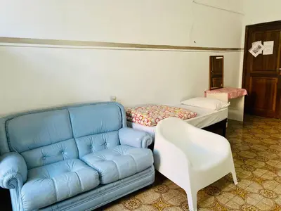 a blue couch and a white chair in a room at ROMA GONDOLA SRLS in Rome