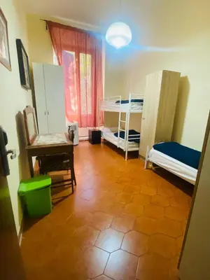 a room with two bunk beds and a chair at ROMA GONDOLA SRLS in Rome