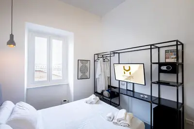a bedroom with a white bed and a window at Fastime in Rome