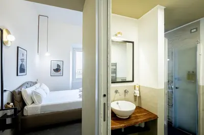 a bathroom with a bed and a sink in a room at Fastime in Rome