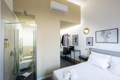 a bedroom with a bed and a bathroom with a shower at Fastime in Rome