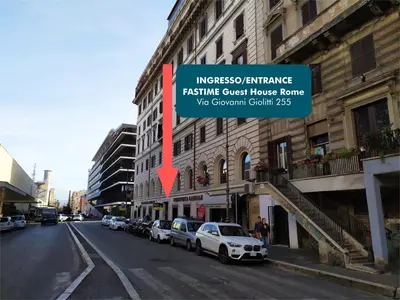 a street with cars parked on the side of a building at Fastime in Rome