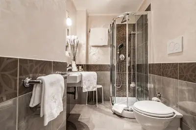 a bathroom with a toilet and a shower and a sink at Al Relais in Rome