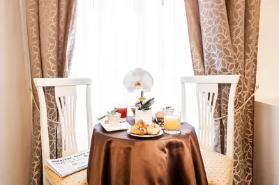 a table with a plate of food on it in front of a window at Al Relais in Rome