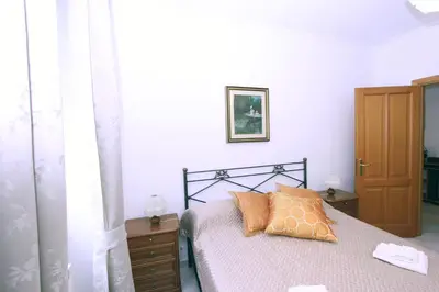 a bedroom with a bed with two pillows on it at Torrigio Flat in Rome