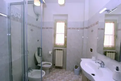 a bathroom with a sink and a toilet and a shower at Torrigio Flat in Rome