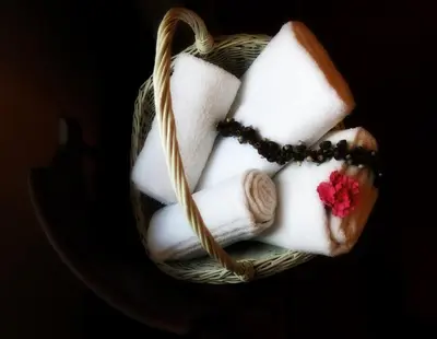 a basket filled with towels and a rosary at NIK Rooms in Rome
