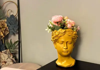 a gold head with flowers on top of it at NIK Rooms in Rome