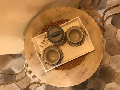 a wooden table with three bowls on a plate at Colosseo Sweet Home in Rome