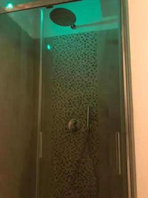 a shower with a glass door in a bathroom at Colosseo Sweet Home in Rome