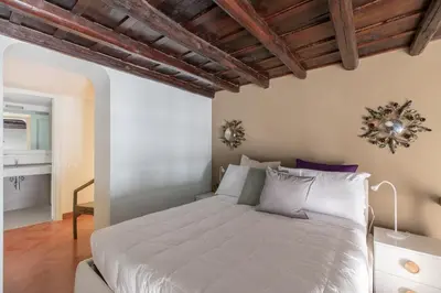 a bedroom with a large bed in a room at iFlat Pantheon Historic Two-Story Apartment in Rome