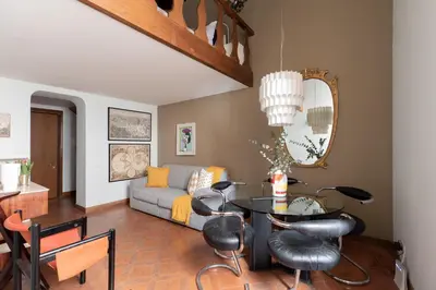 a living room with a table and a couch at iFlat Pantheon Historic Two-Story Apartment in Rome