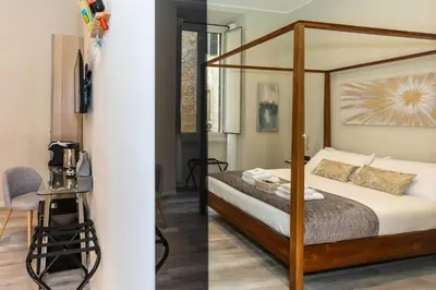 a bedroom with a canopy bed in a room at Suites 44 - Guesthouse close to Vaticano, San Pietro, Castel Sant'angelo in Rome