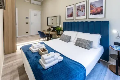 a bedroom with a large bed with towels on it at Suites 44 - Guesthouse close to Vaticano, San Pietro, Castel Sant'angelo in Rome
