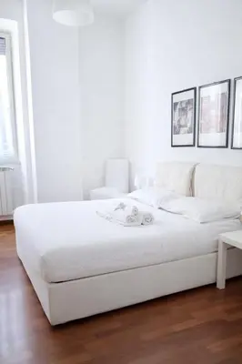 a white bedroom with a large white bed in a room at Comfort spazio e privacy 2 camere 2 bagni e self check in nel cuore di San Giovanni in Rome