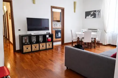 a living room with a couch and a television and a table at Comfort spazio e privacy 2 camere 2 bagni e self check in nel cuore di San Giovanni in Rome