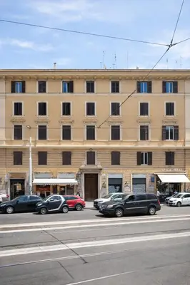 a large building with cars parked in front of it at Comfort spazio e privacy 2 camere 2 bagni e self check in nel cuore di San Giovanni in Rome