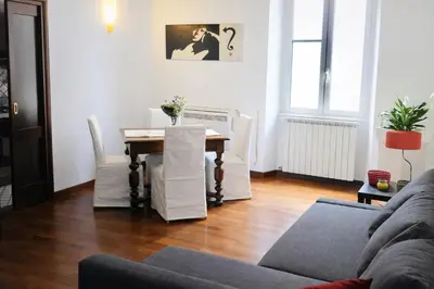 a living room with a table and a couch at Comfort spazio e privacy 2 camere 2 bagni e self check in nel cuore di San Giovanni in Rome