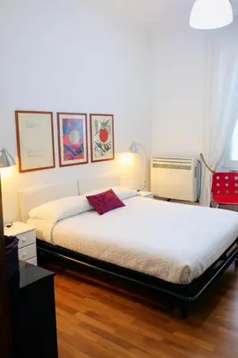 a bedroom with a large bed and a radiator at Comfort spazio e privacy 2 camere 2 bagni e self check in nel cuore di San Giovanni in Rome