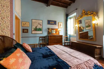 a bedroom with a large bed and a mirror at The Dreamers House in Rome