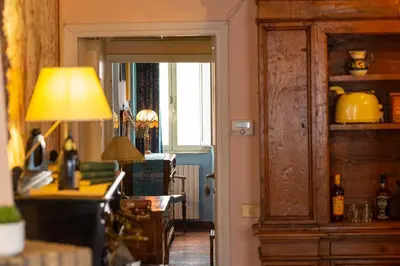 a kitchen with a table and a lamp and a door at The Dreamers House in Rome