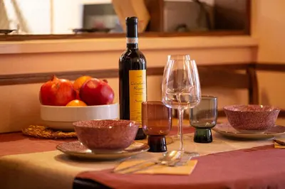 a bottle of wine sitting on a table with glasses at The Dreamers House in Rome