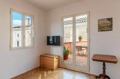 a living room with a sliding glass door and a table at Apartment with Terrace in via del Pellegrino - FromHometoRome in Rome