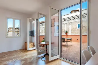 a room with glass doors and a table and a dining room at Apartment with Terrace in via del Pellegrino - FromHometoRome in Rome