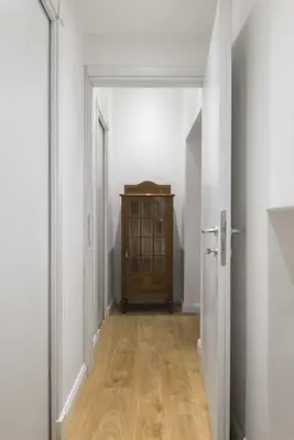 an empty hallway with a wooden cabinet in a room at Corso 101 in Rome