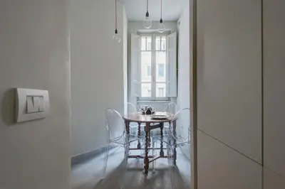 a dining room with a table and chairs and a window at Casa Satrico in Rome