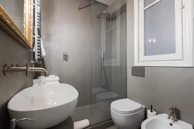 a bathroom with a sink and a toilet and a shower at Casa Satrico in Rome