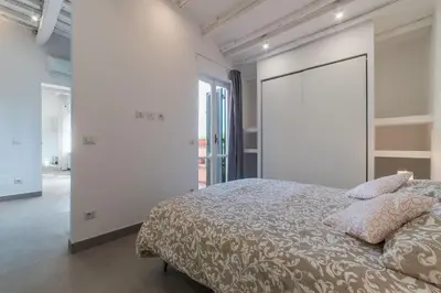 a bedroom with a bed and a large sliding door at GuestHost - Piazza Navona Panoramic Penthouse in Rome