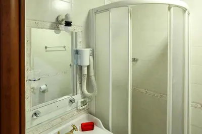 a bathroom with a shower and a sink and a mirror at Lydka Domus in Rome