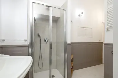 a glass shower in a bathroom with a sink at Boutique Apartment Pantheon in Rome