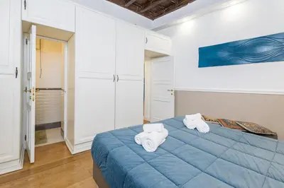 a bedroom with a blue bed with towels on it at Boutique Apartment Pantheon in Rome