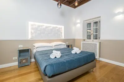 a bedroom with a large bed with towels on it at Boutique Apartment Pantheon in Rome