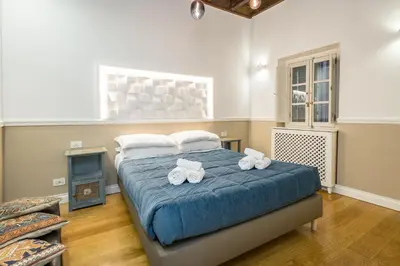a bedroom with a bed with two towels on it at Boutique Apartment Pantheon in Rome