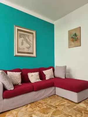 a red couch in a room with a blue wall at Vatican Fairytale Garden in Rome