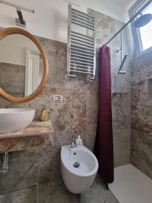 a bathroom with a sink and a mirror at Vatican Fairytale Garden in Rome
