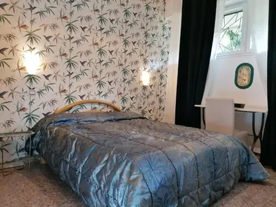 a bedroom with a bed and a wall with a wallpaper at Vatican Fairytale Garden in Rome