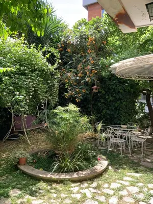 a garden with a table and chairs and plants at Vatican Fairytale Garden in Rome