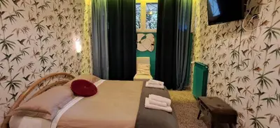 a room with a bed and a table and a window at Vatican Fairytale Garden in Rome